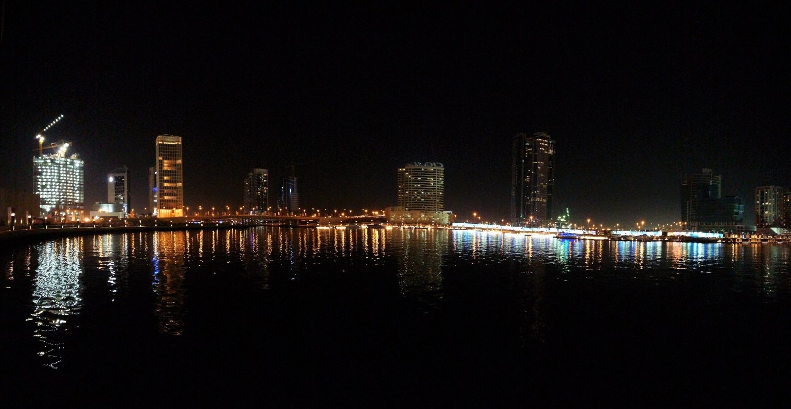 Business Bay towers along the Dubai Water Canal at night