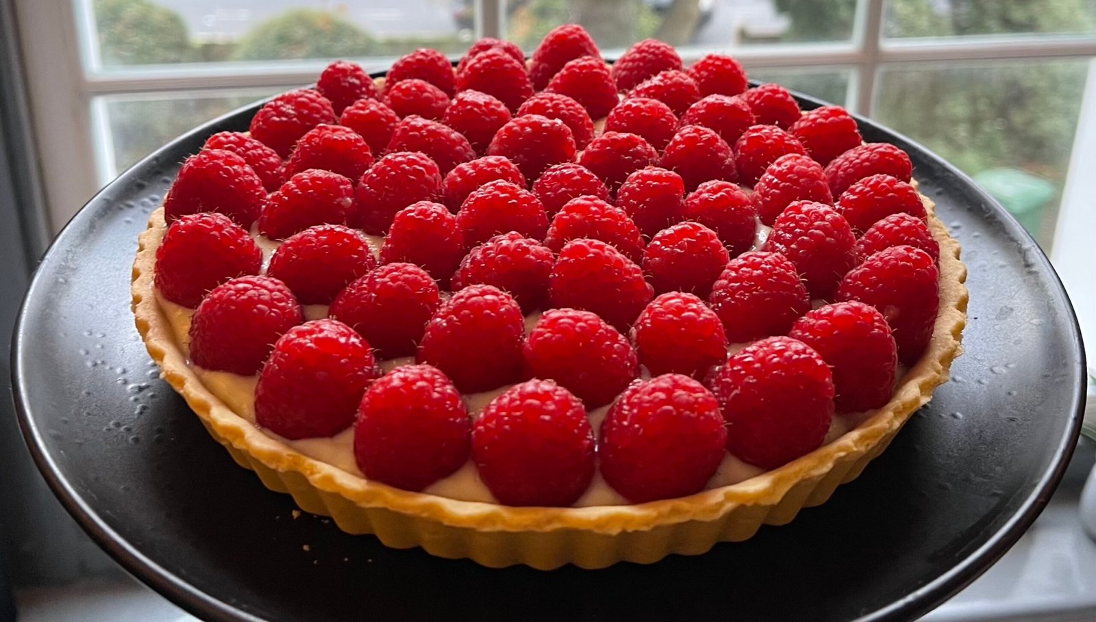 Raspberry tart with custard cream.
