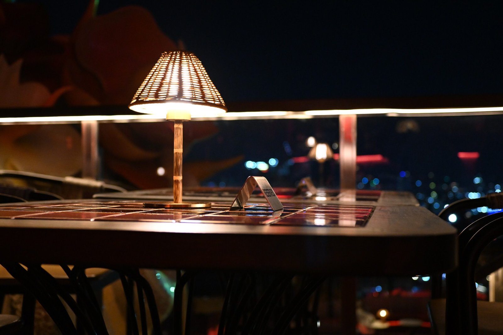 This photo shows an intimate nighttime dining scene, likely at an outdoor restaurant or terrace in Pattaya, Thailand. Th